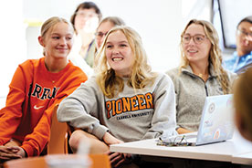 Students smiling in class. Link to Beneficiary Designations Students smiling in class. Link to Beneficiary Designations
